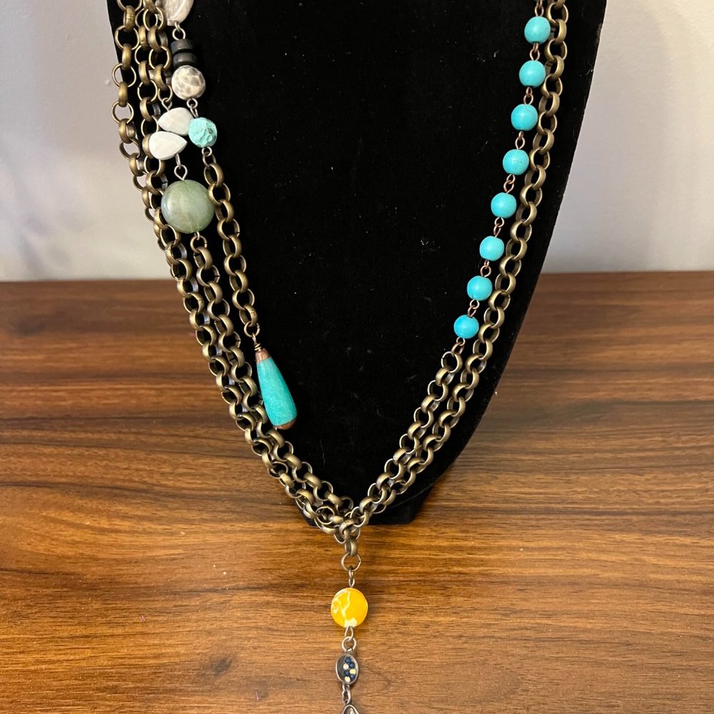 Necklace with tassel strands and bee charm